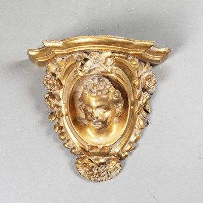 Lot 467 - A CARVED ITALIAN GILTWOOD CHERUB WALL CORBEL.