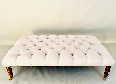 Lot 589 - HEARTH STOOL WITH NEUTRAL LINEN DEEP BUTTONED UPHOLSTERY ON TURNED SUPPORTS.