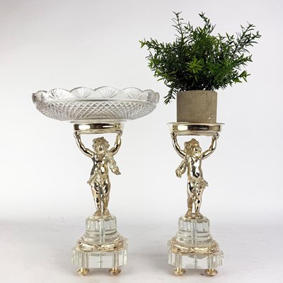 Lot 191 - PUTTI FORM SILVER PLATED AND CUT GLASS TAZZA AND CANDLE HOLDER (2).