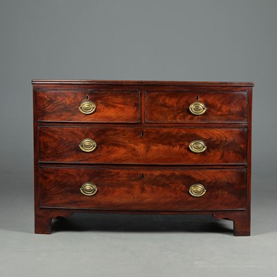 Lot 318 - EARLY 19TH CENTURY MAHOGANY LOW BOWFRONT CHEST.