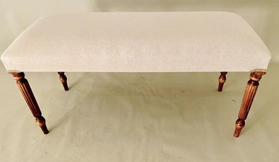 Lot 252 - STOOL IN NEUTRAL LINEN UPHOLSTERY ON REEDED SUPPORTS