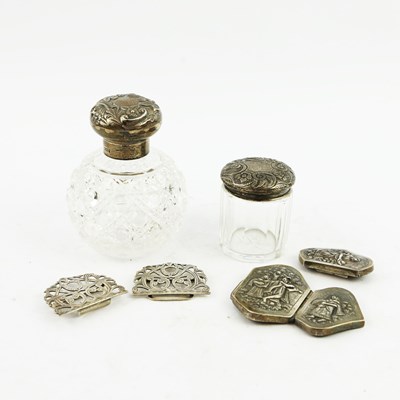 Lot 144 - TWO BELT BUCKLES AND SILVER CAPPED GLASS DRESSING TABLE BOTTLES. (4)