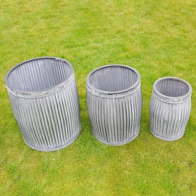 Lot 243 - GRADUATED SET OF THREE RIBBED ZINC GARDEN PLANTERS.