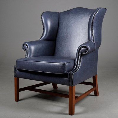 Lot 326 - WING ARMCHAIR IN STUDDED BLUE LEATHER UPHOLSTERY.
