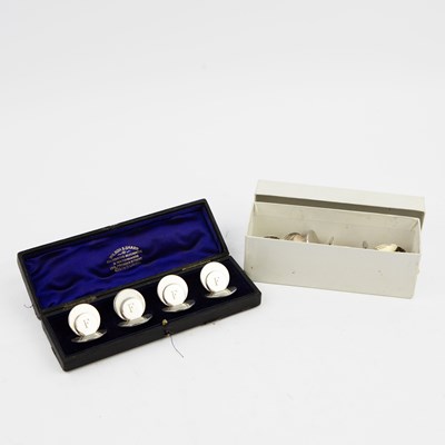 Lot 184 - A SET OF SILVER MENU HOLDERS.