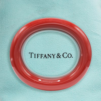 Lot 335 - A TIFFANY RED LACQUERERD BANGLE